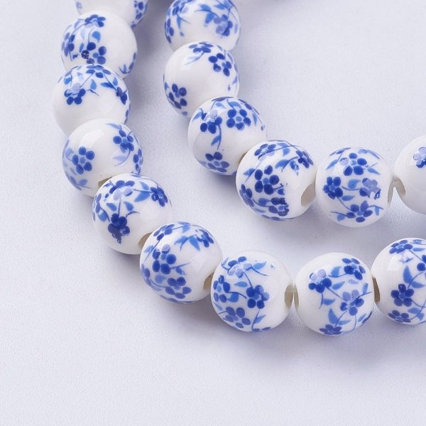 697a Koraliki ceramiczne z nadrukiem kwiatowym, okrągłe 8-8,5 mm, otwór: 2 mm, sznur ok 33cm