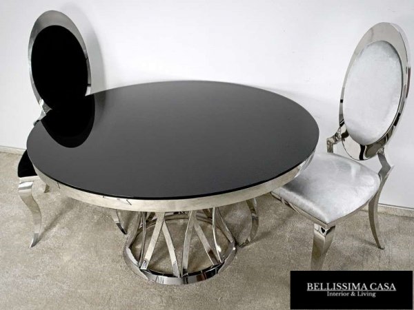 Okrągły stół z ciemnym blatem i dekoracyjną podstawą art deco