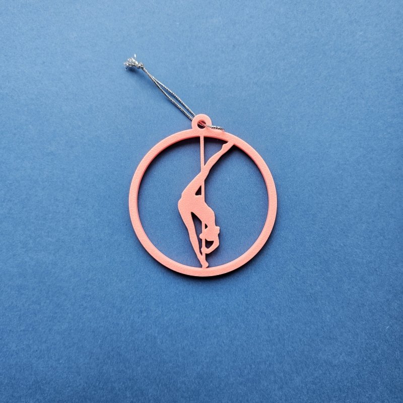 Pink Glow in the Dark Pole Dance Ornament (Pose C) on a blue background. Amira Perun Aerial Fitness