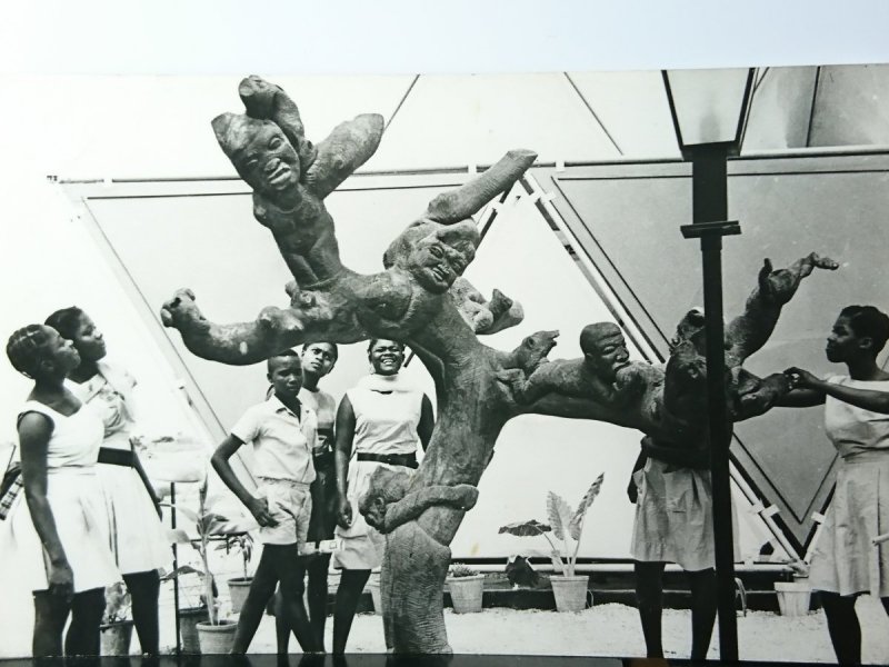 SCHOOL CHILDREN ADMIRING WOOD CARVING